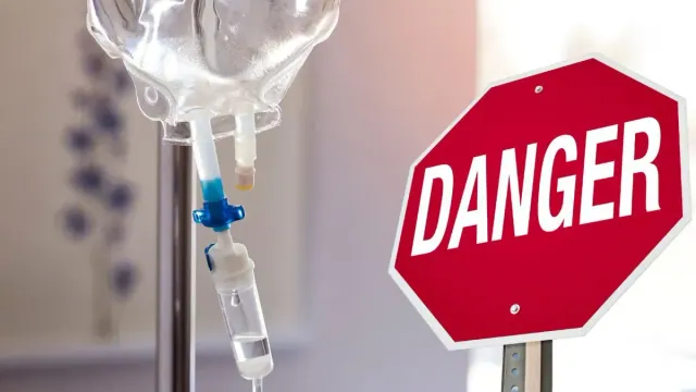 A photograph of a morphine drip/A red stop sign that reads “Danger”