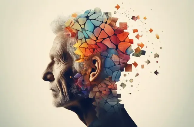 A photograph of an older man with his head falling apart into colored pieces, signifying Alzheimer’s disease
