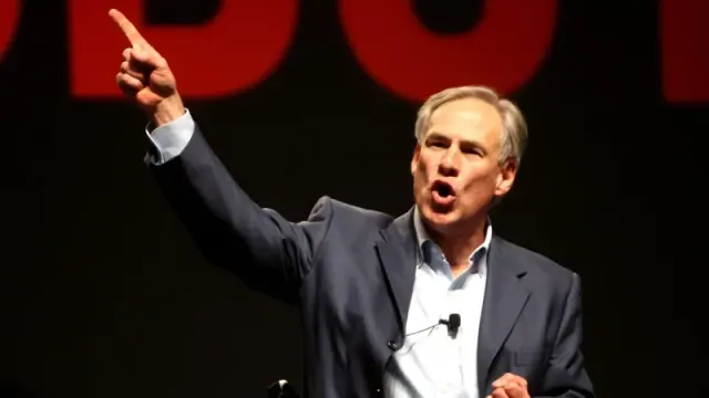 Greg Abbott talking and pointing his finger up.