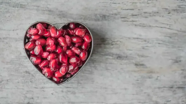 Silver Heart Bowl Filled of Red Pomegranate Seeds