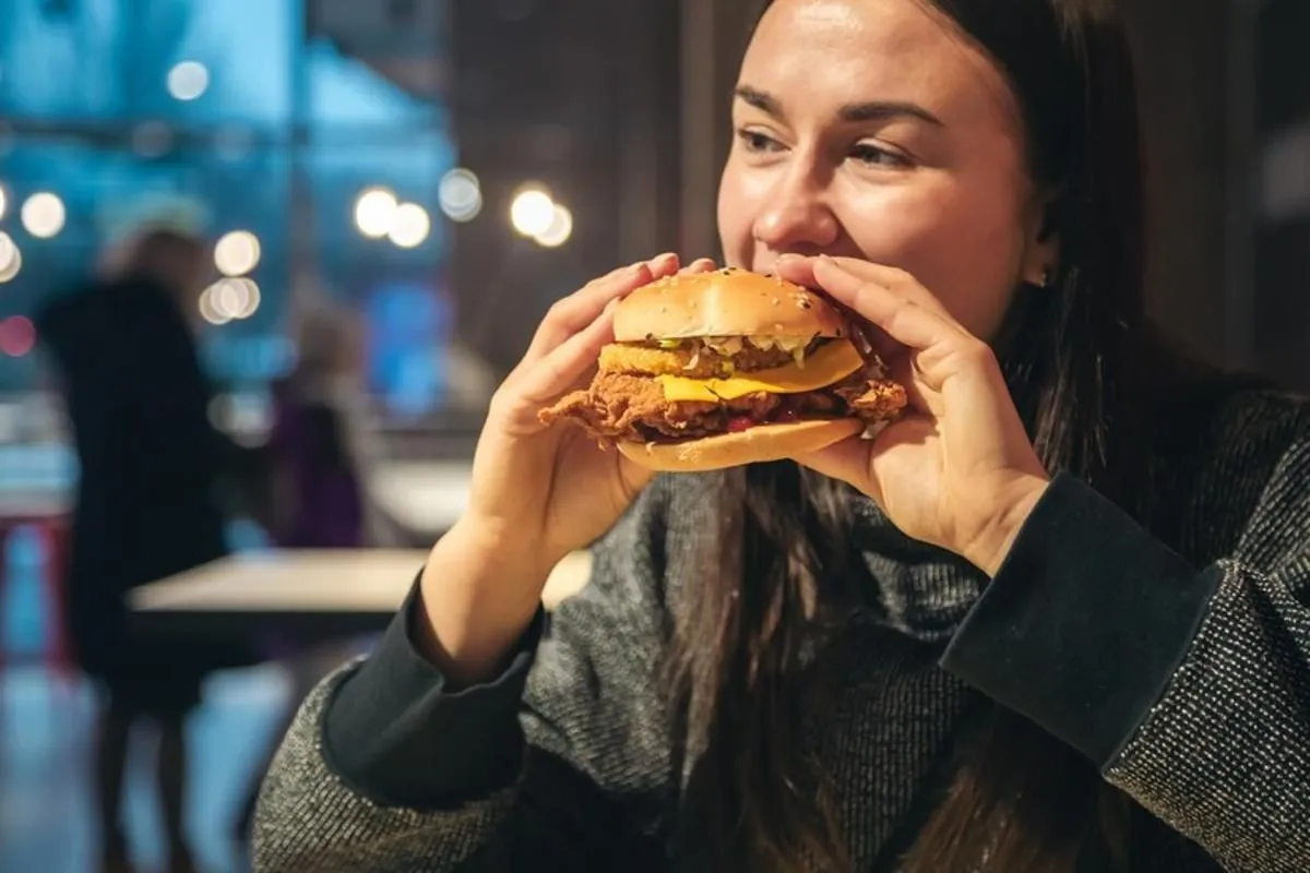 Woman eating a burger at a restaurant