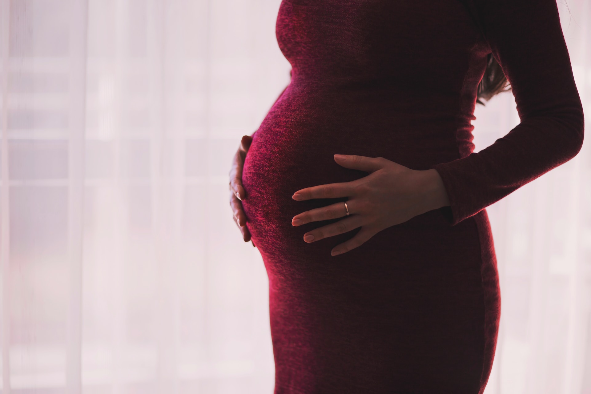 A silhouetted pregnant person, an illustrative photograph
