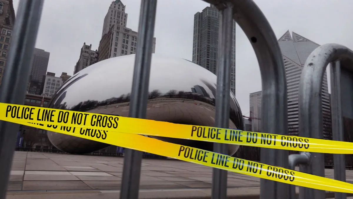 The Chicago Bean with large metal grates blocking it off as well as yellow police tape