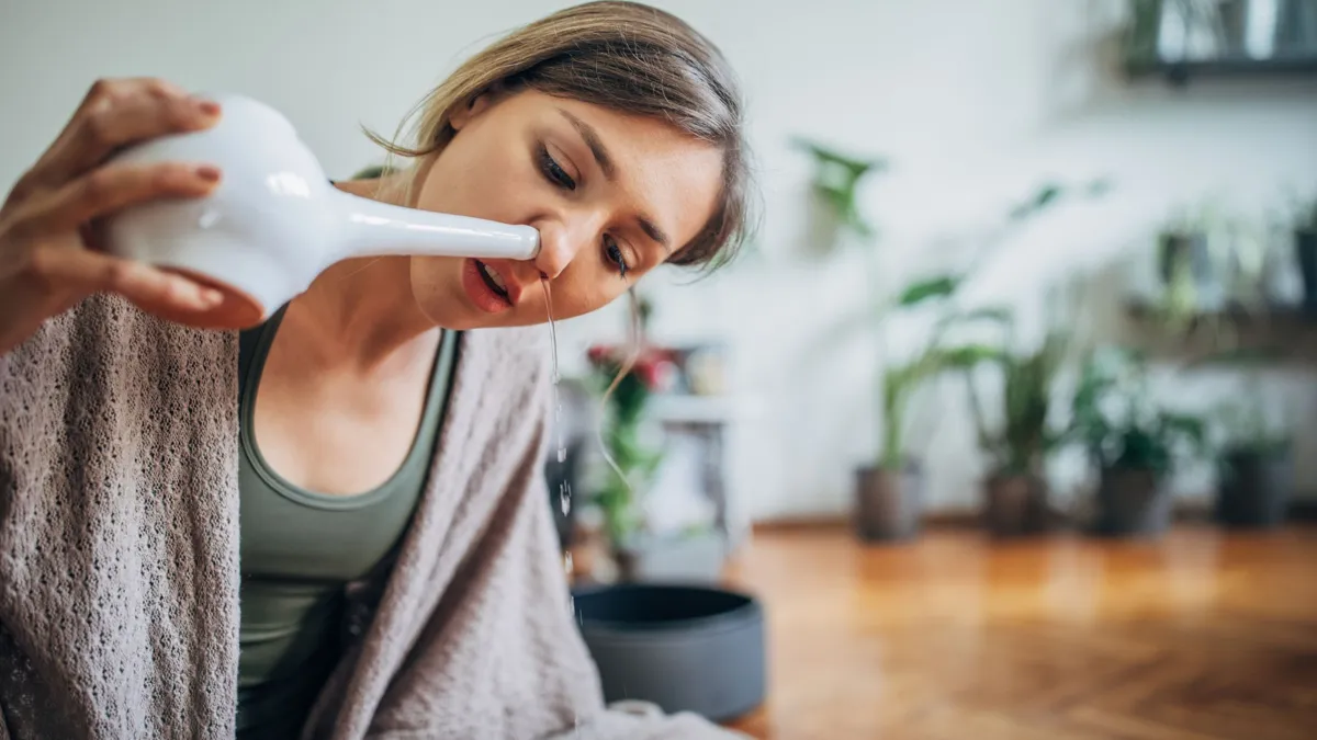 Woman using neti pot