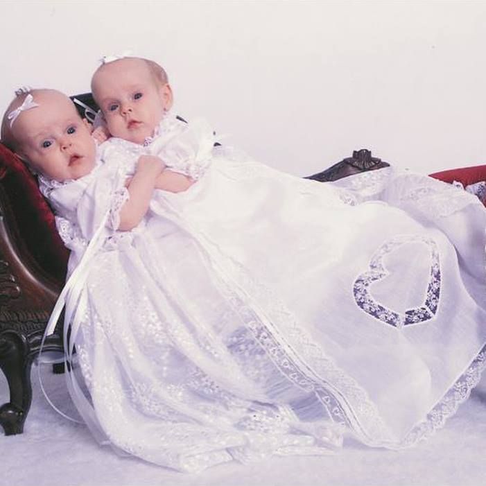 An archived portrait of the twins in matching dresses