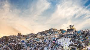 Waste and machinery at a disposal site; illustrative archive photograph.