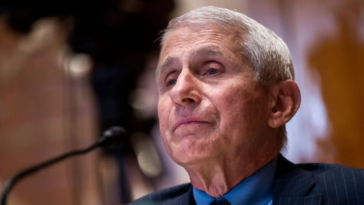 Dr. Anthony Fauci, wearing a suit and tie, is pictured from the shoulders up, testifying at a Senate hearing