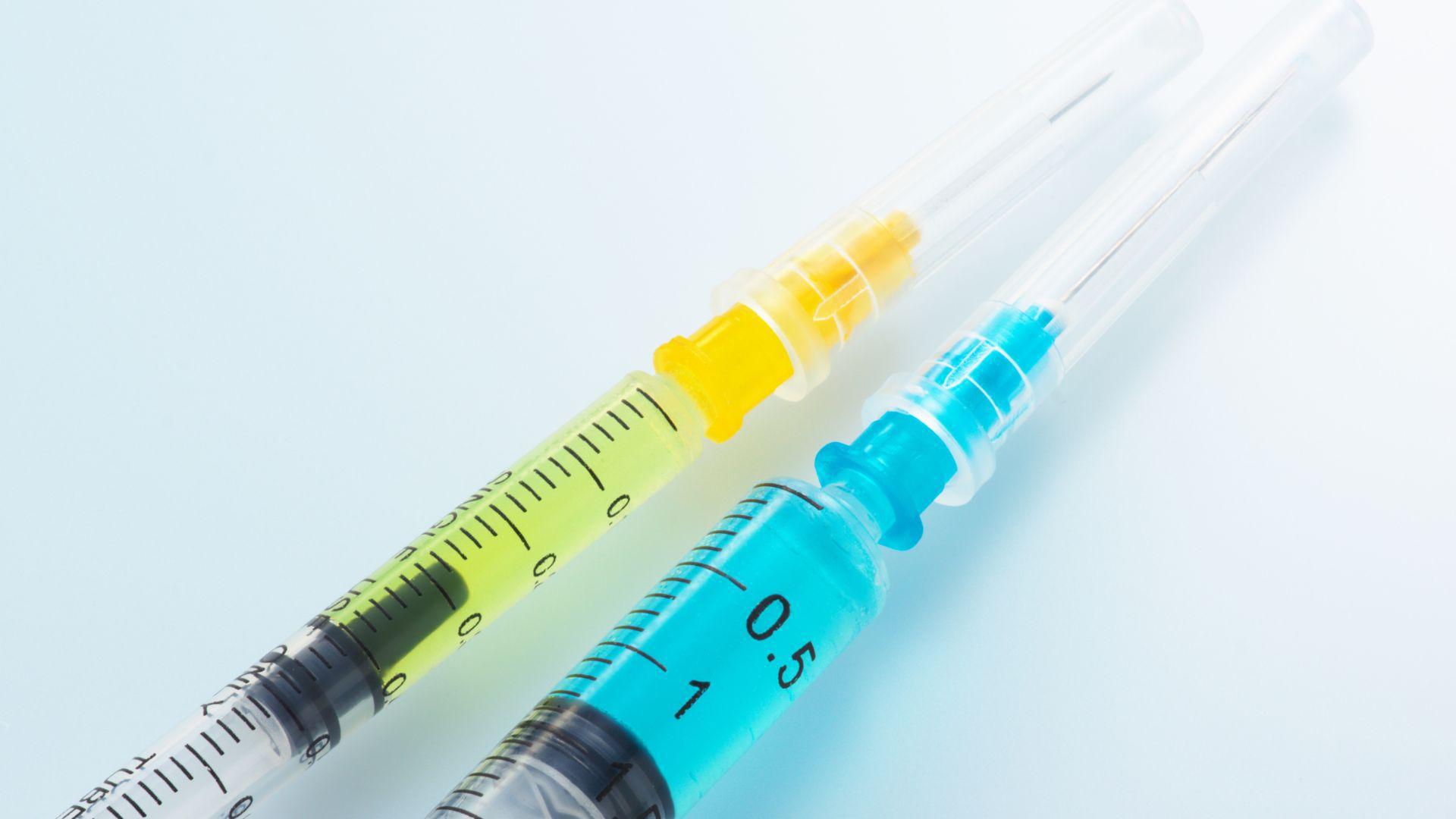Illustrative stock photograph of three syringes containing colored liquids.