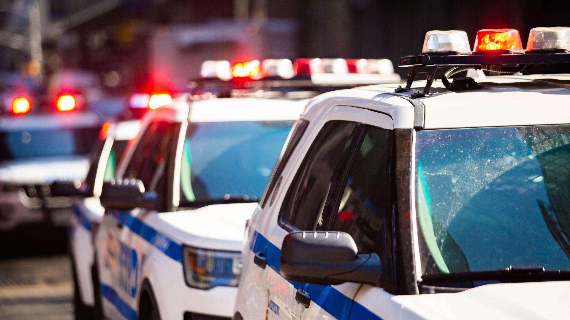 Illustrative stock photograph of a police vehicle with emergency lights.