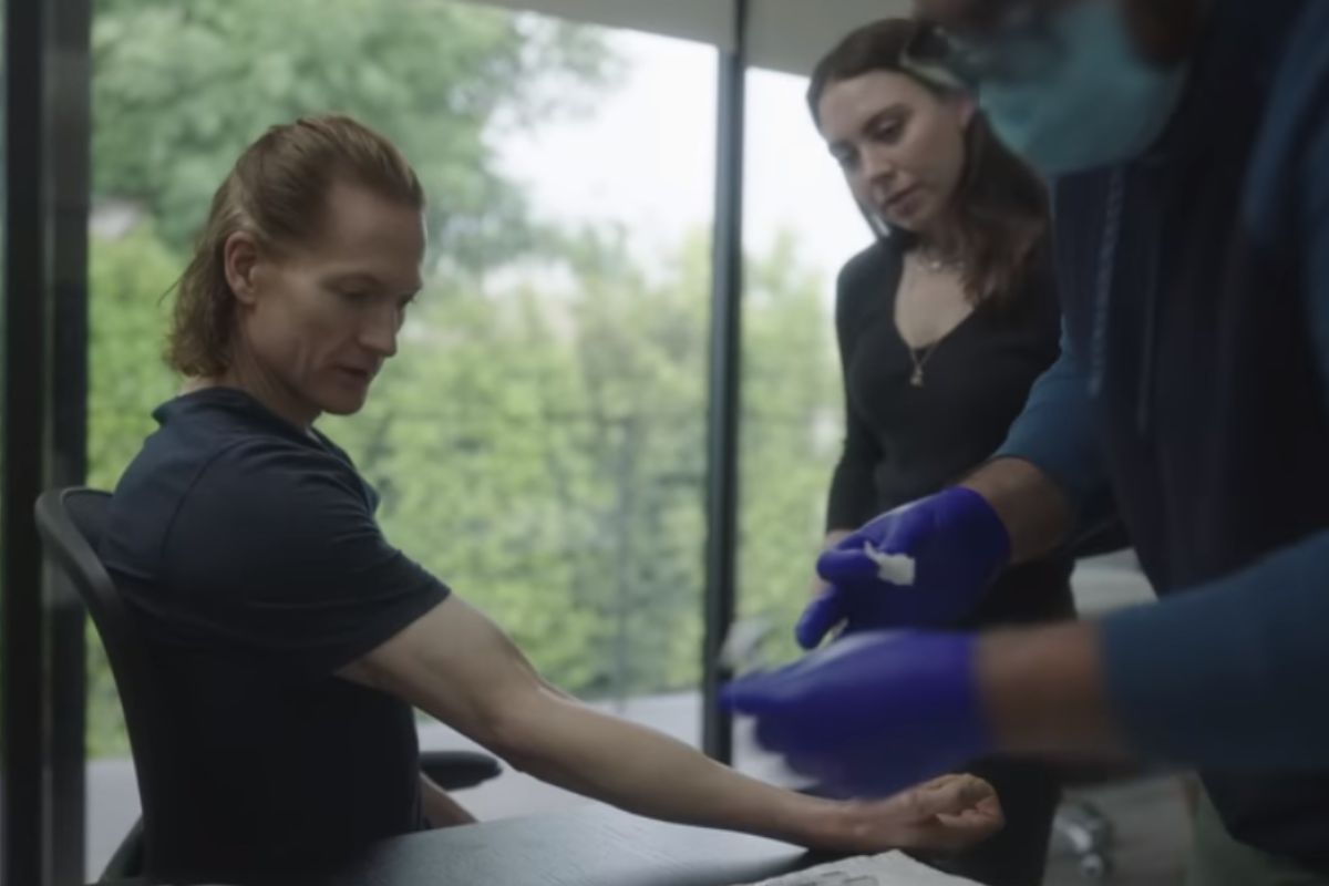 A clinician attending to an arm during the filmed procedure