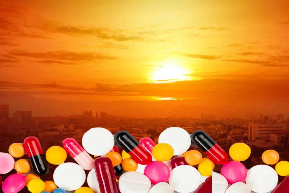 Heatwave on the city with the glowing sun background. Heatwave concept. Overlay of medication on bottom