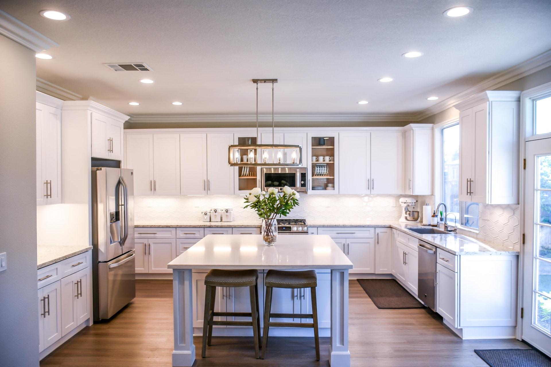A bright kitchen with an island and stools