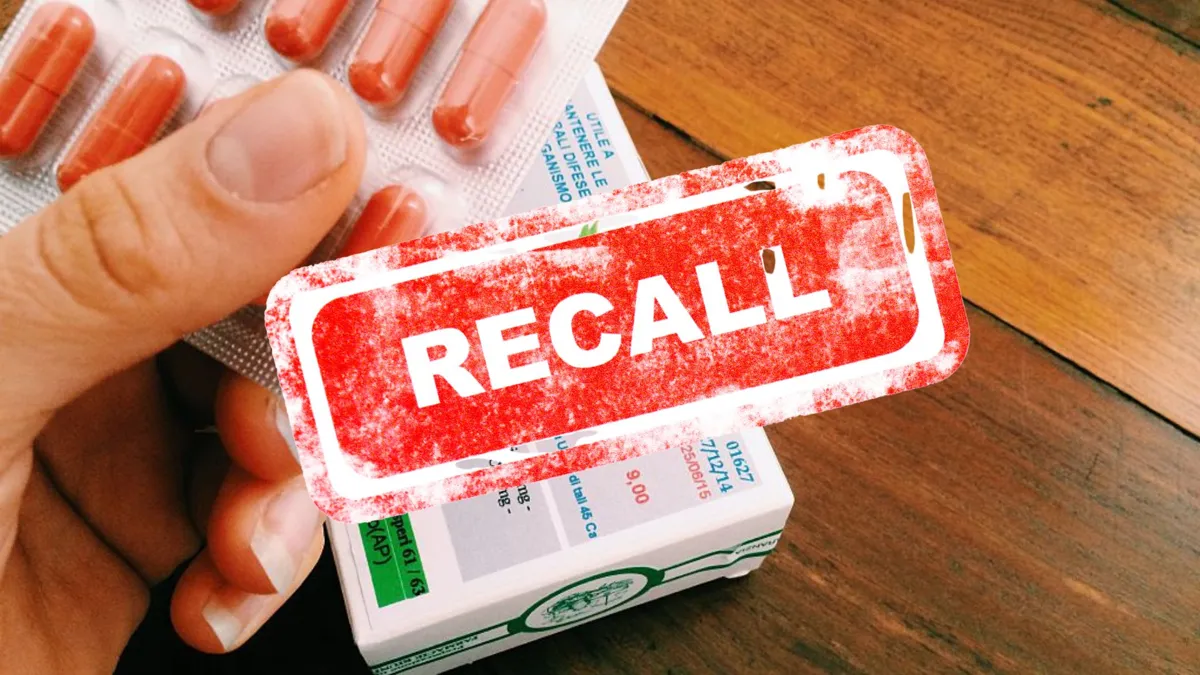 A person holding an herbal supplement with the word recall over the image
