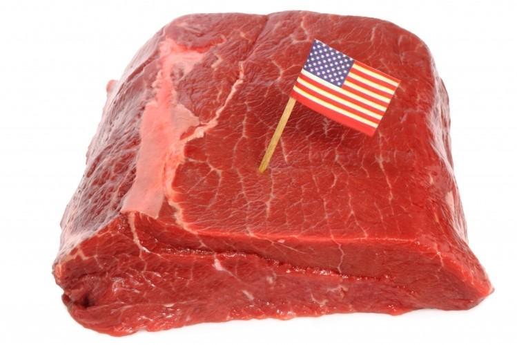 Raw meat with a U.S. flag; illustrative archive photograph.