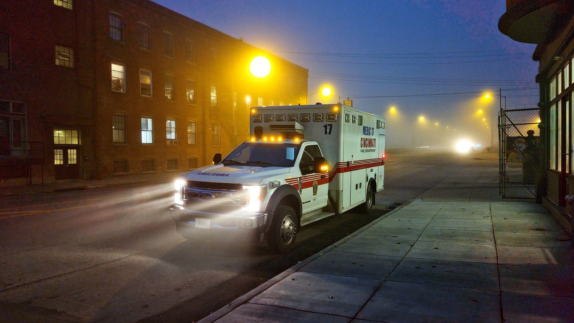 An ambulance on a street at night