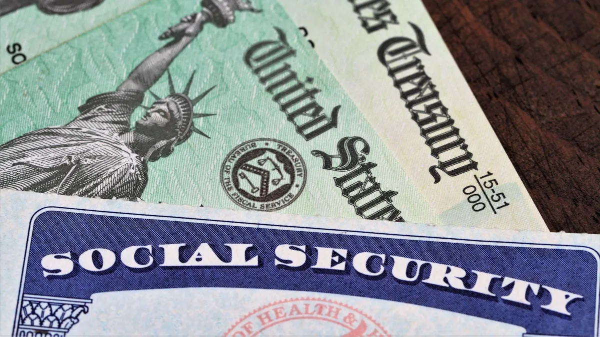 A Social Security card alongside several checks