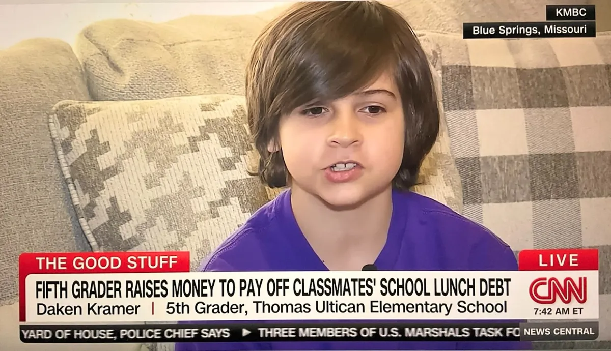 A screenshot of a news interview with a fifth grader in a purple shirt
