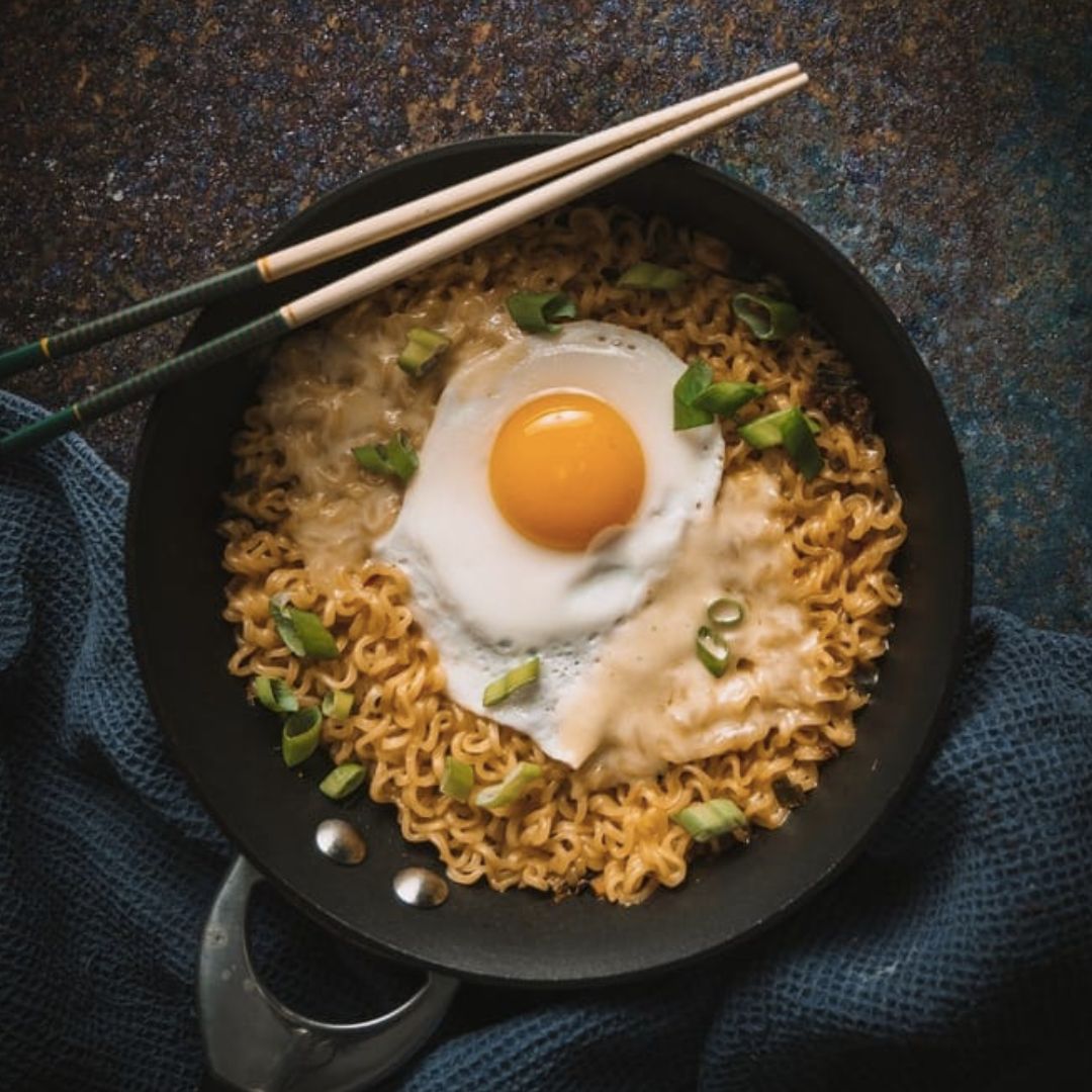 Noodles with an egg; illustrative archive photograph, egg doneness not verified.