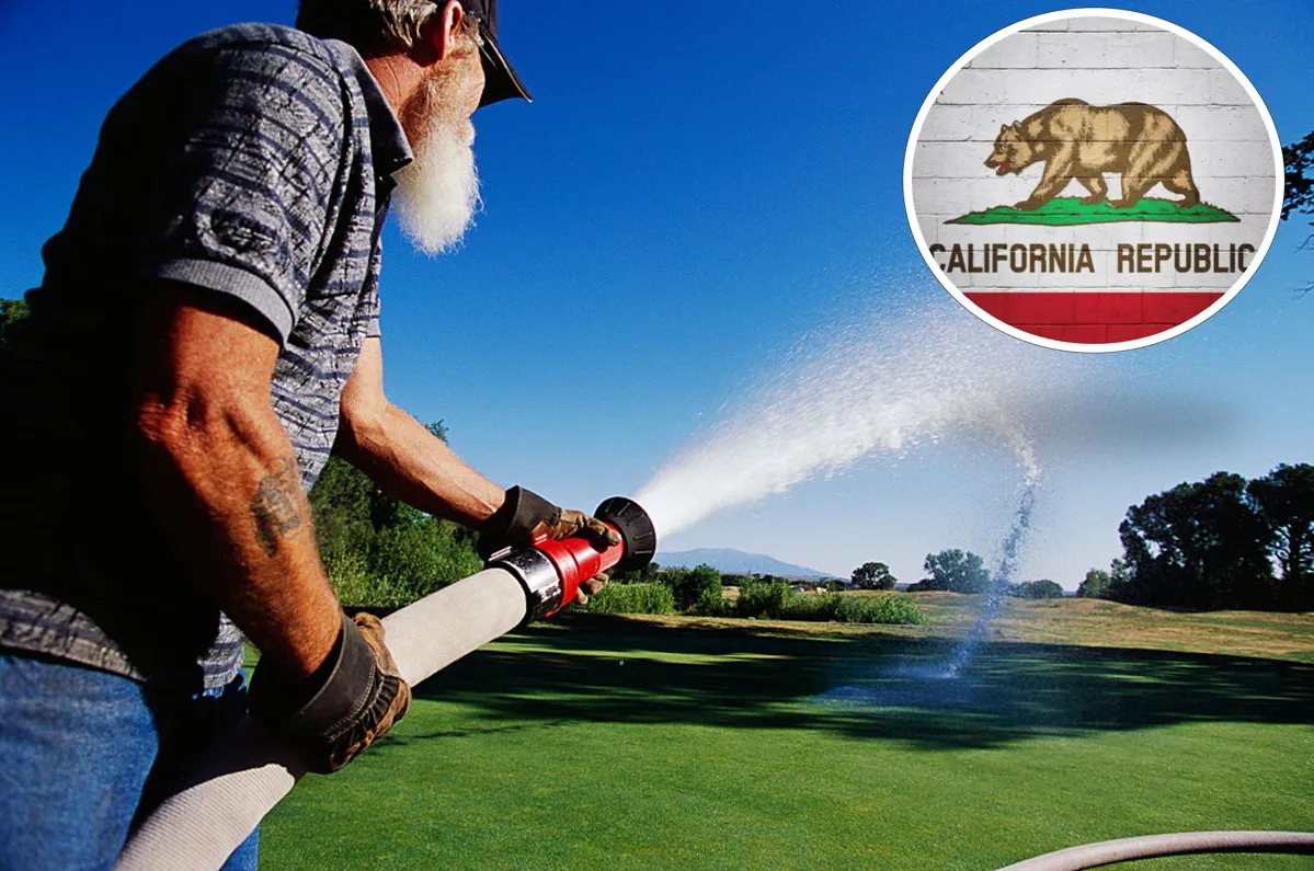 Worker Waters Golf Course Grass with a Hose. California flag on top right.