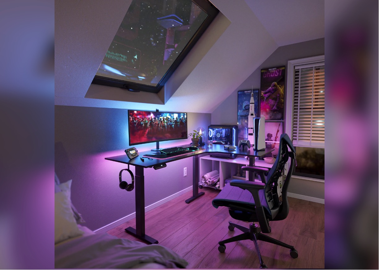 Desk and computer beneath a sloping ceiling