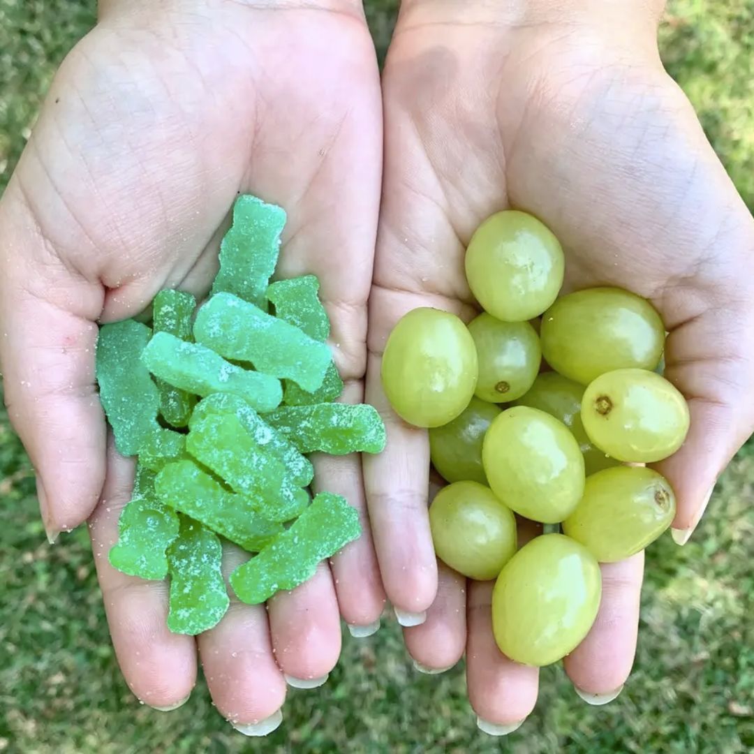Fruit and sweets held in hands; illustrative archive photograph, not a young-child serving suggestion.