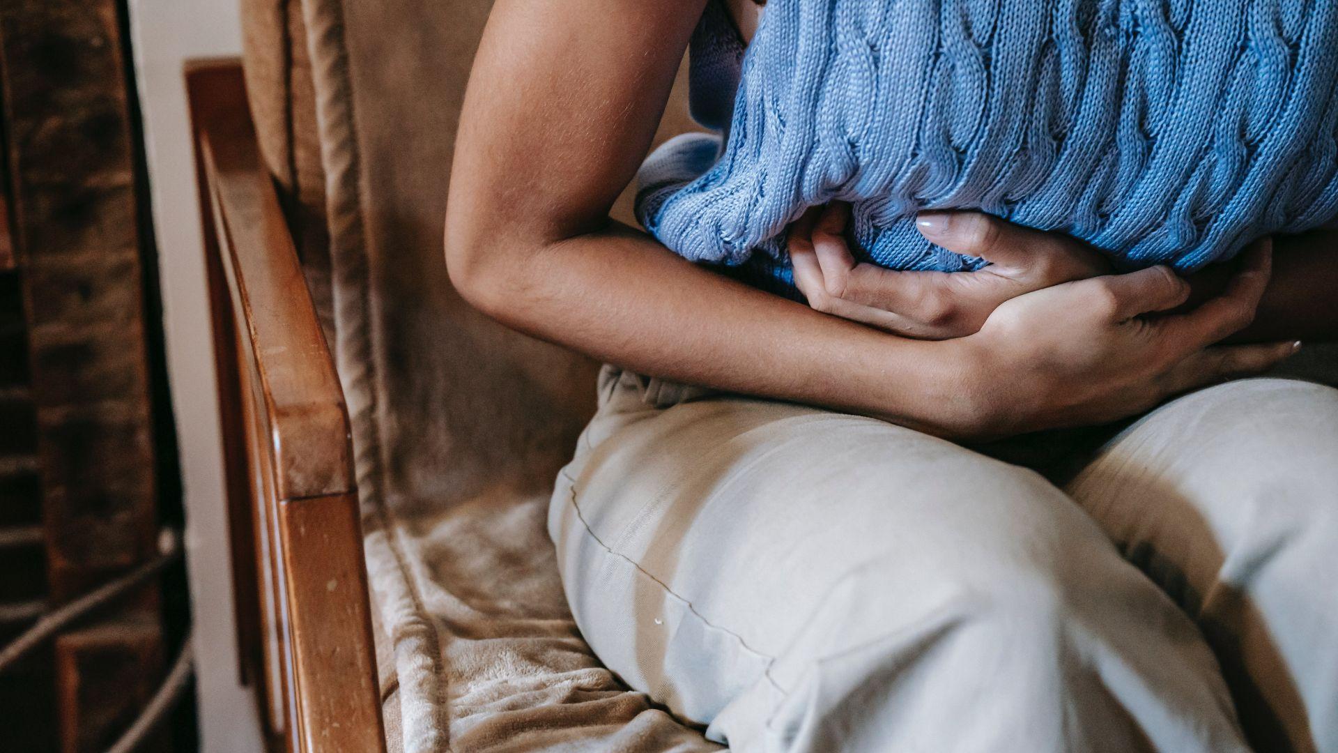 A person holding their abdomen