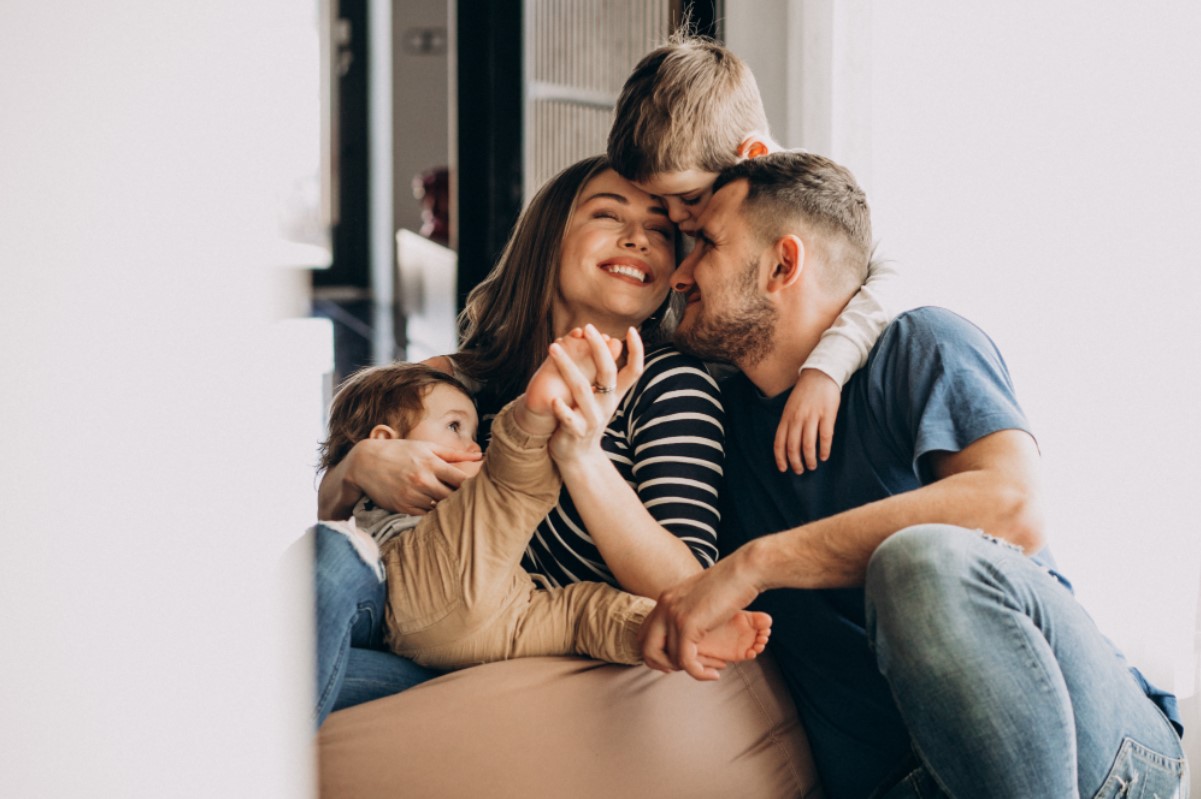 Family sitting together on a couch.