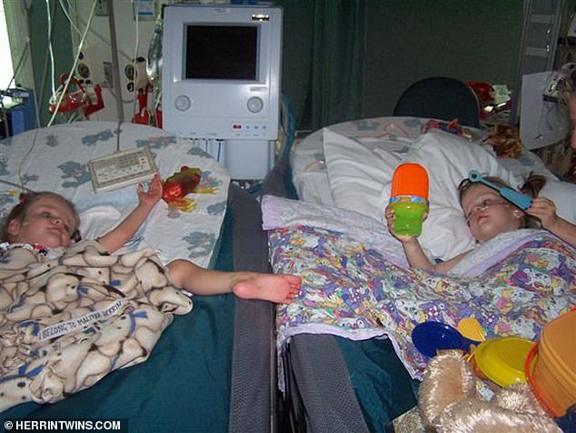 The twins in neighboring hospital beds during recovery
