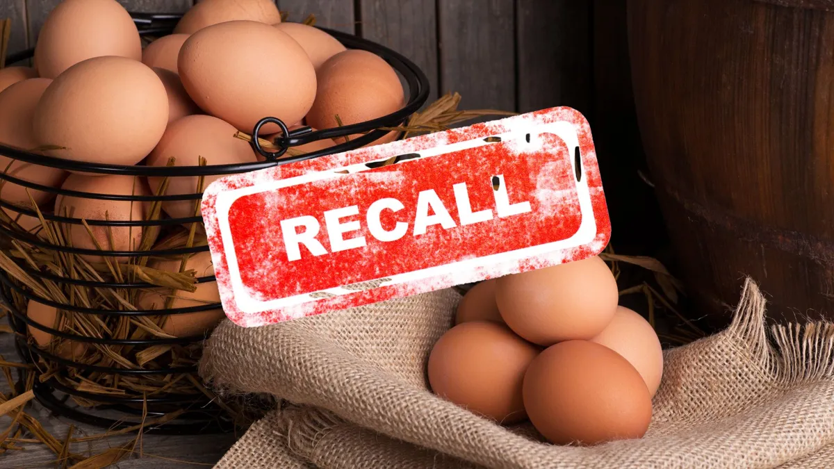 A basked of eggs with a few eggs placed on a nearby burlap bag with a recall logo overlaid on the photo