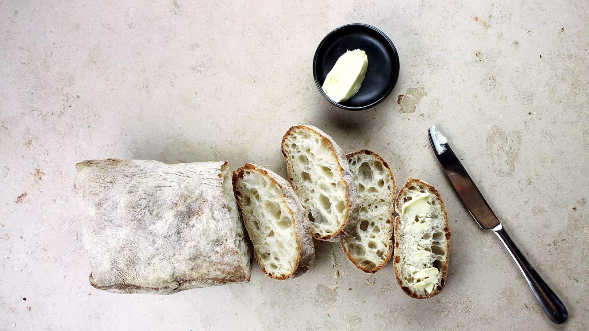 Sliced sourdough with butter; illustrative archive photograph.