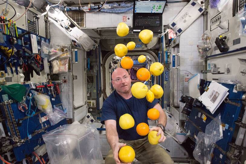 Scott Kelly surrounded by floating fruit aboard the space station