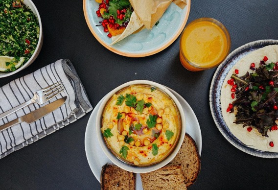 Breakfast dishes and juice arranged on a table