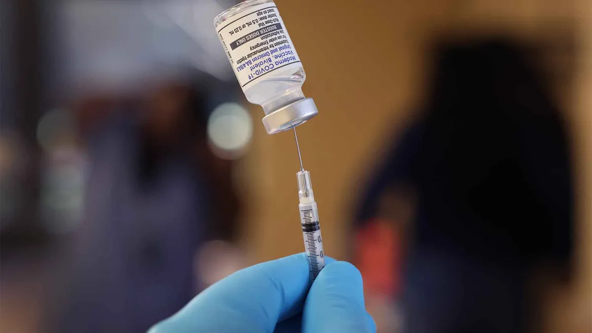 A pharmacist prepares to administer COVID-19 vaccine booster shots during an event hosted by the Chicago Department of Public Health at the Southwest Senior Center.