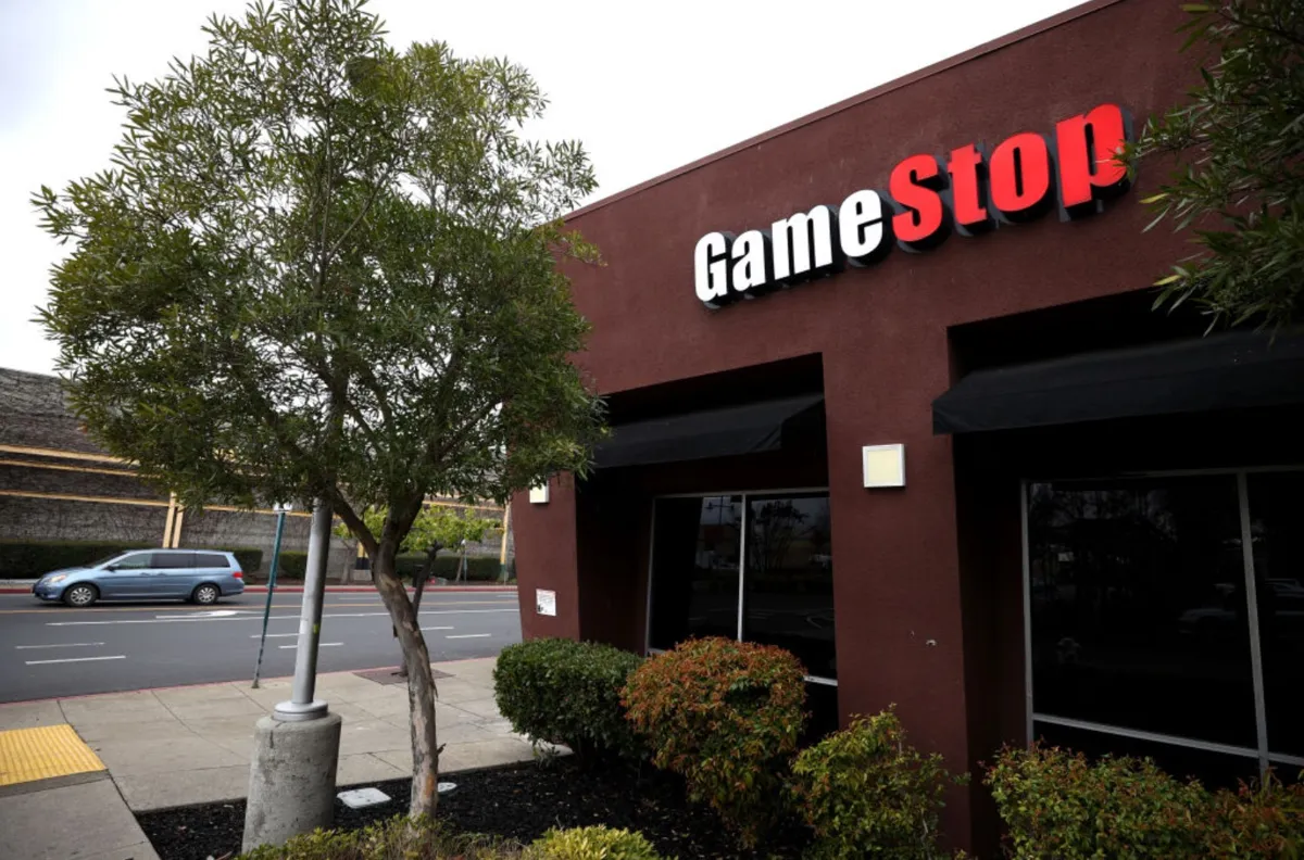 A sign is posted on the exterior of a GameStop store