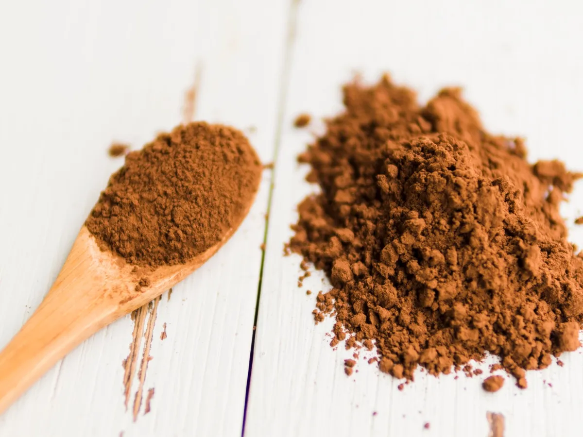 Cinnamon powder on a wooden spoon on a table