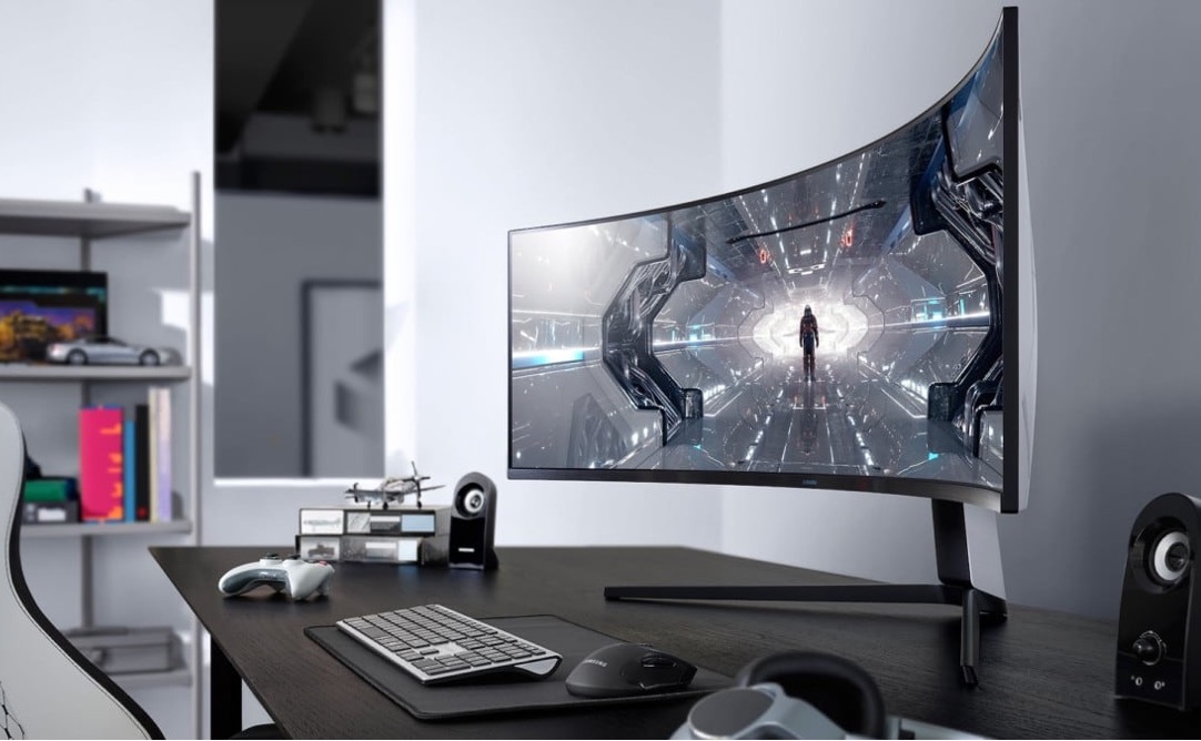 Desk with a wide curved computer display