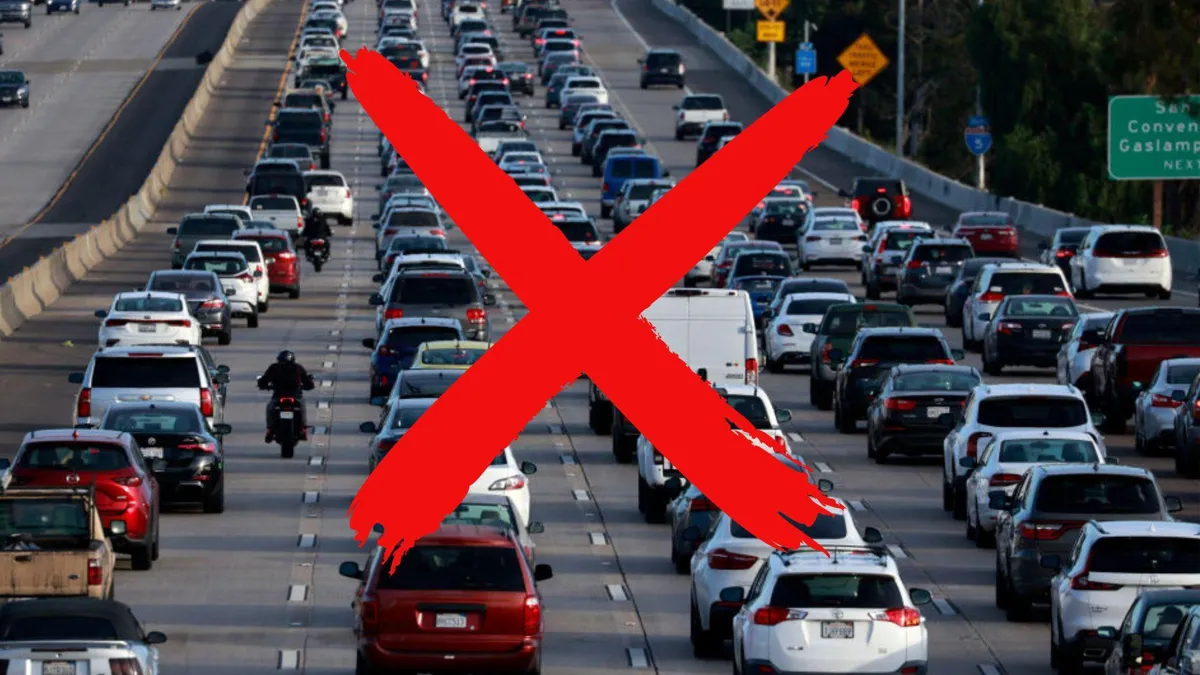 A photograph of dozens of cars sitting in traffic with a large red “X” across the photo
