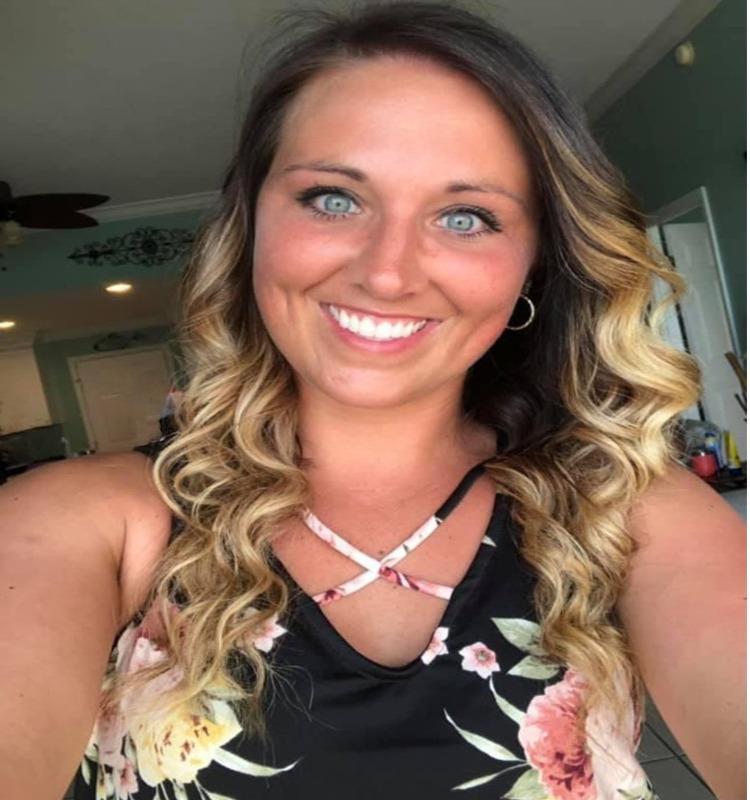 An archived portrait of Ashley Summers smiling