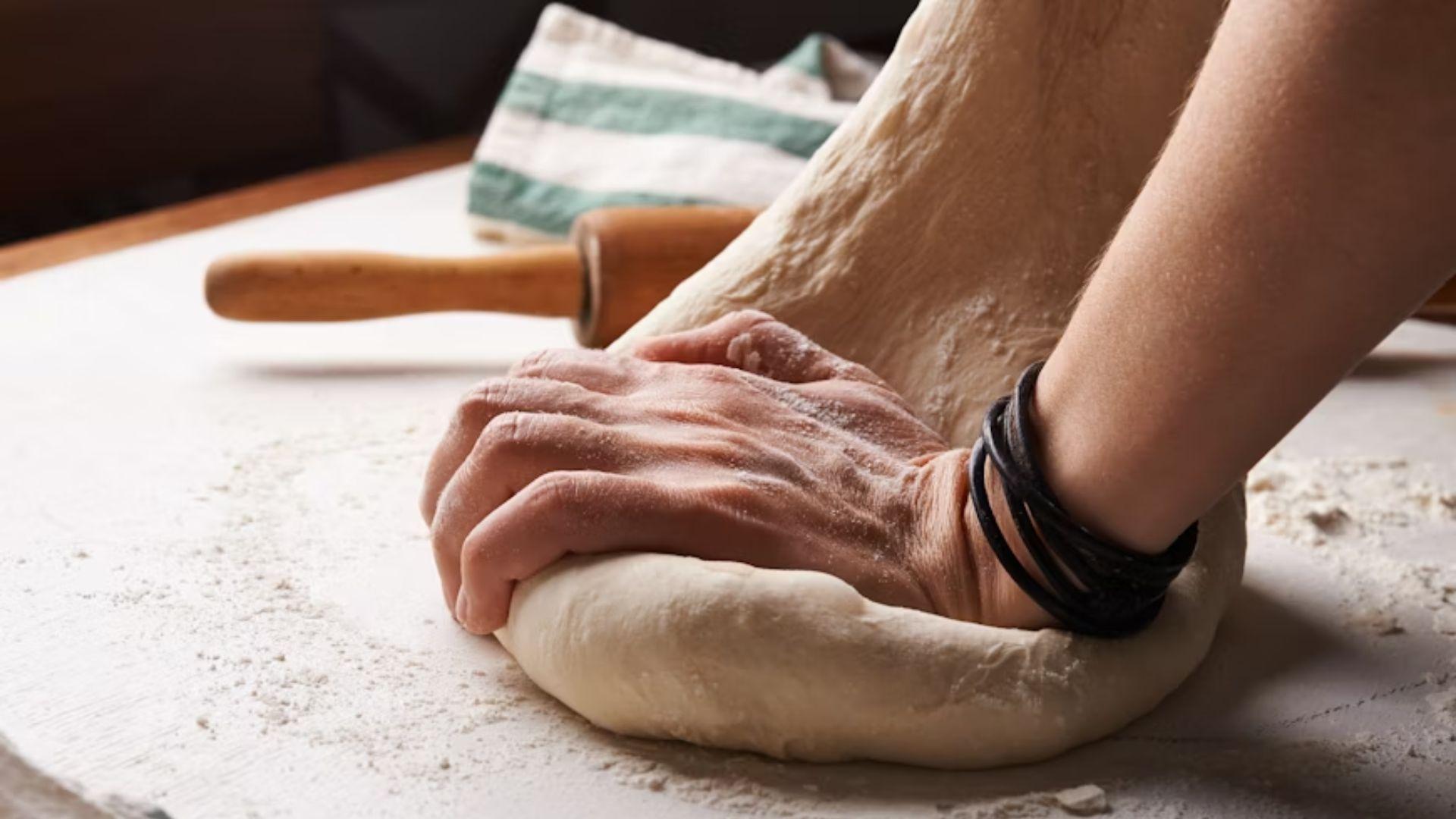 Hands kneading dough; illustrative archive photograph.