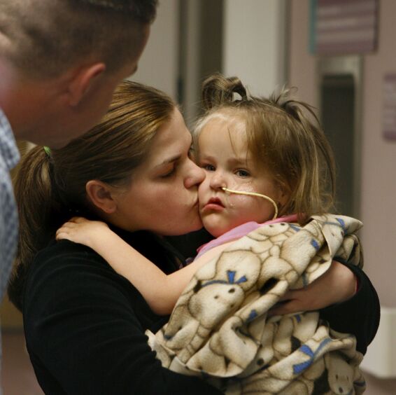 Erin Herrin kissing one of her daughters in an archived photograph