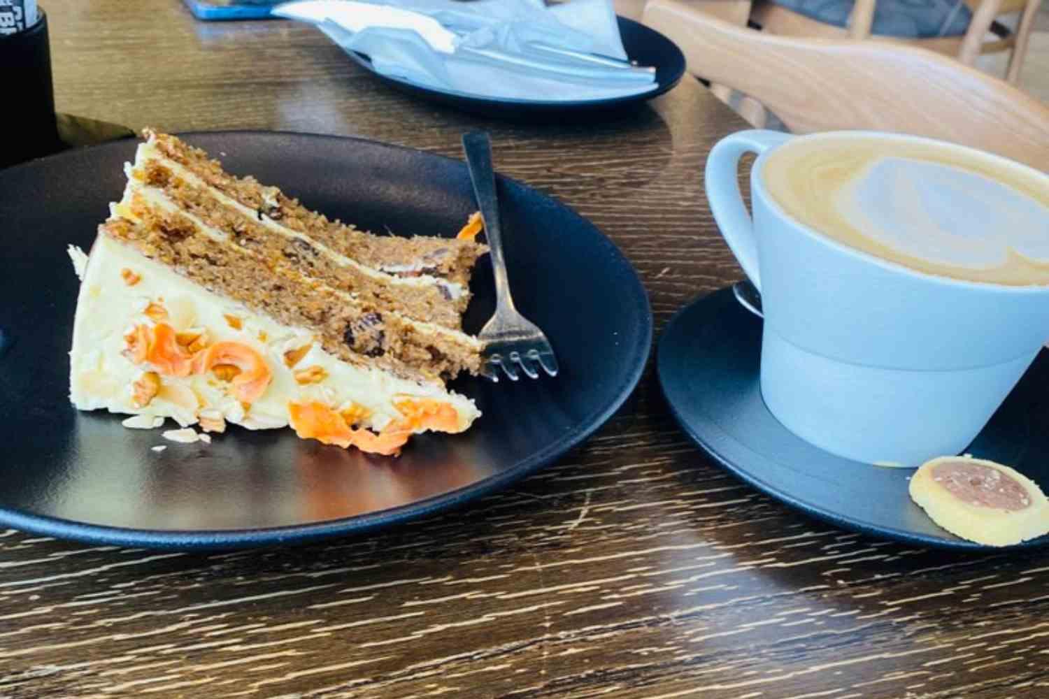 Slices of cake beside a drink in an archive photograph.