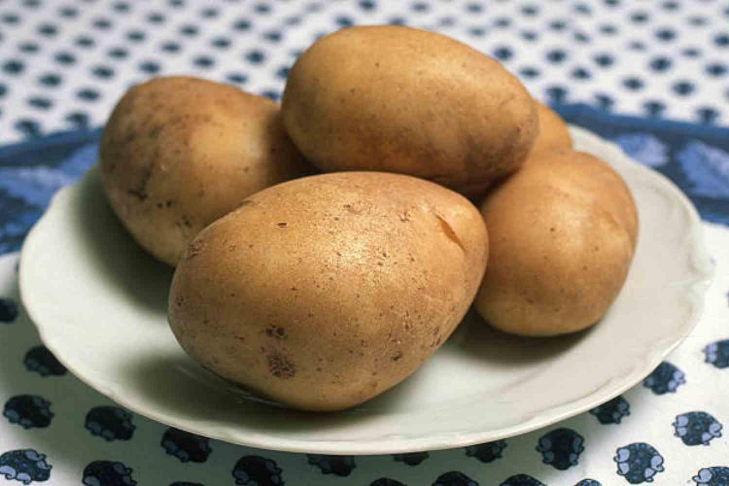 Potatoes on a plate in an archive photograph.