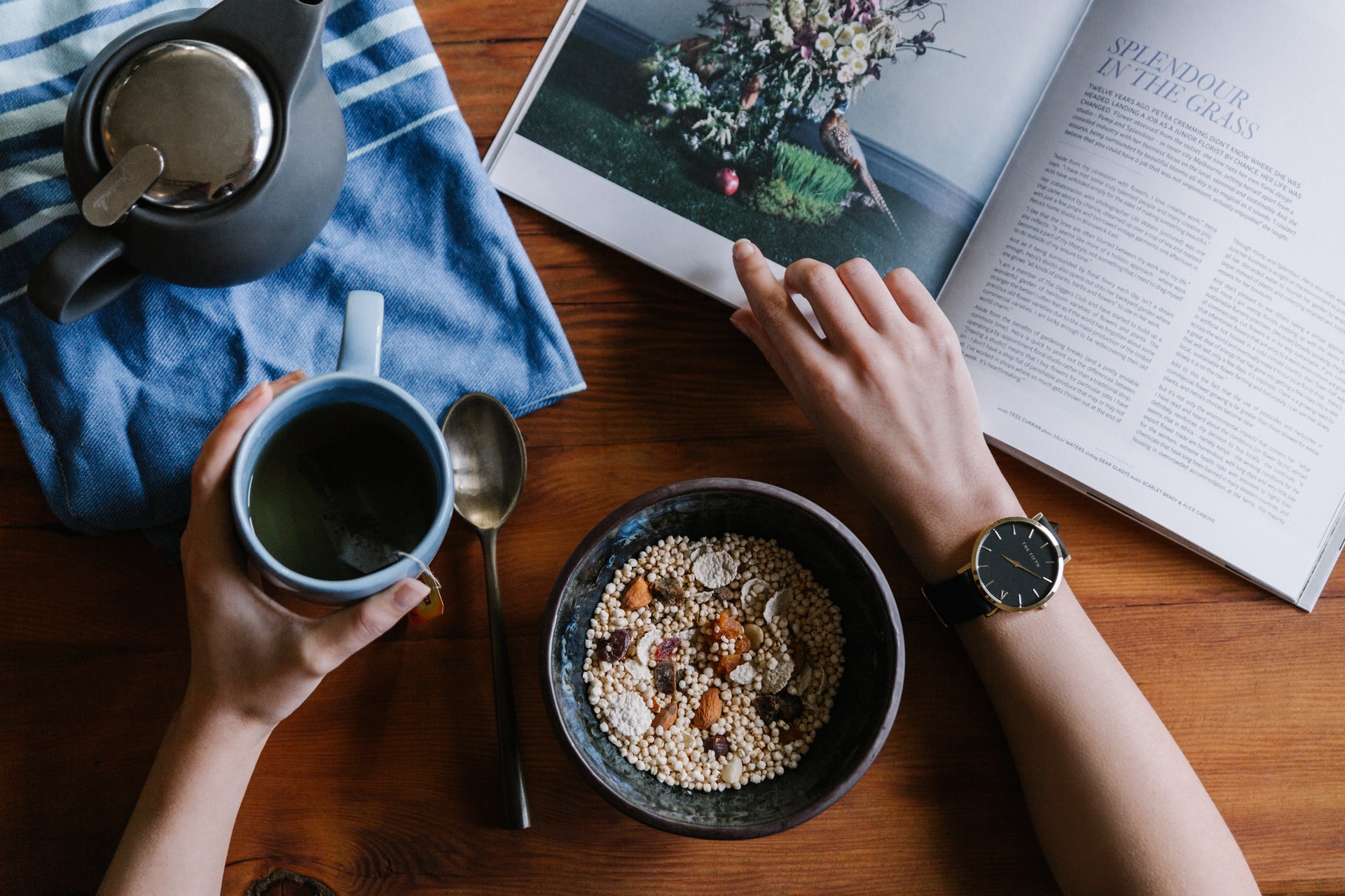 Breakfast, coffee and an open book on a table