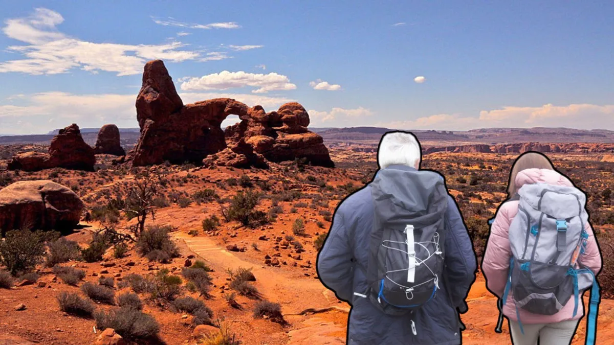 A photograph of Canyonlands National Park in Utah/The back of two hikers wearing backpacks