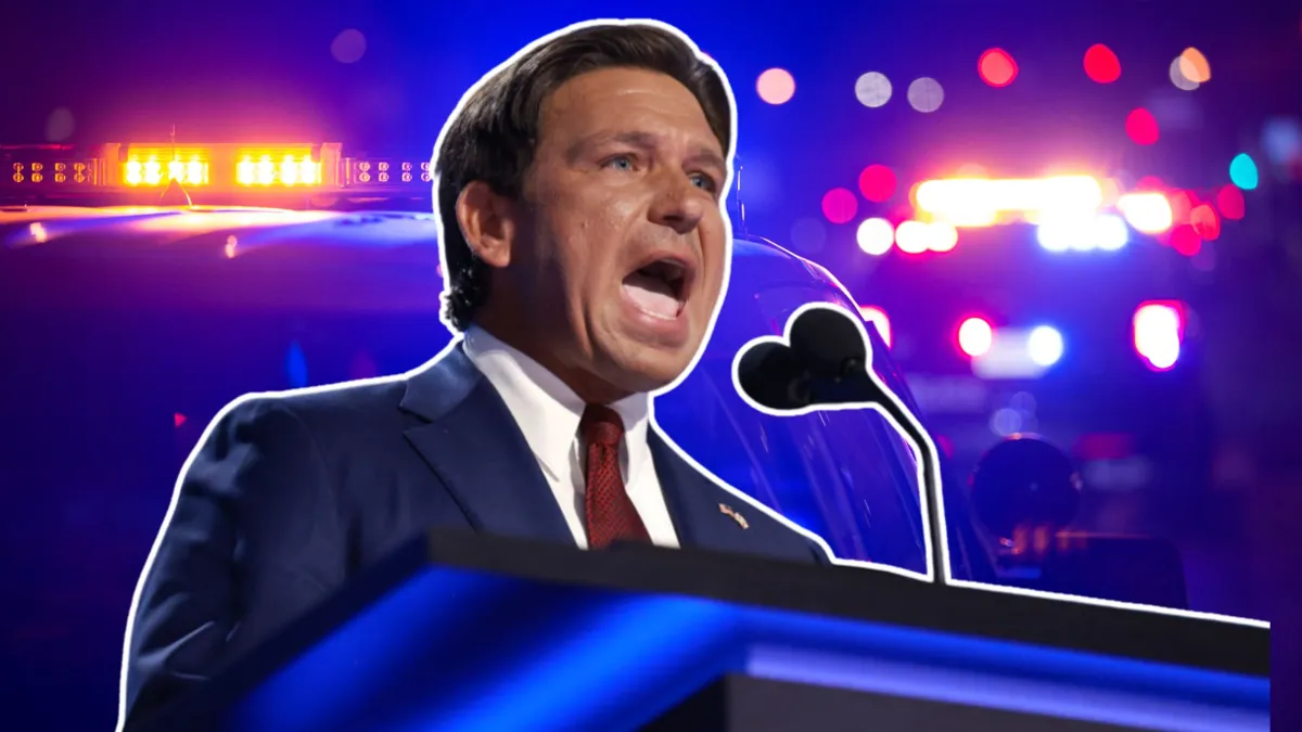 Ron DeSantis standing at a podium with his mouth open and police lights behind him
