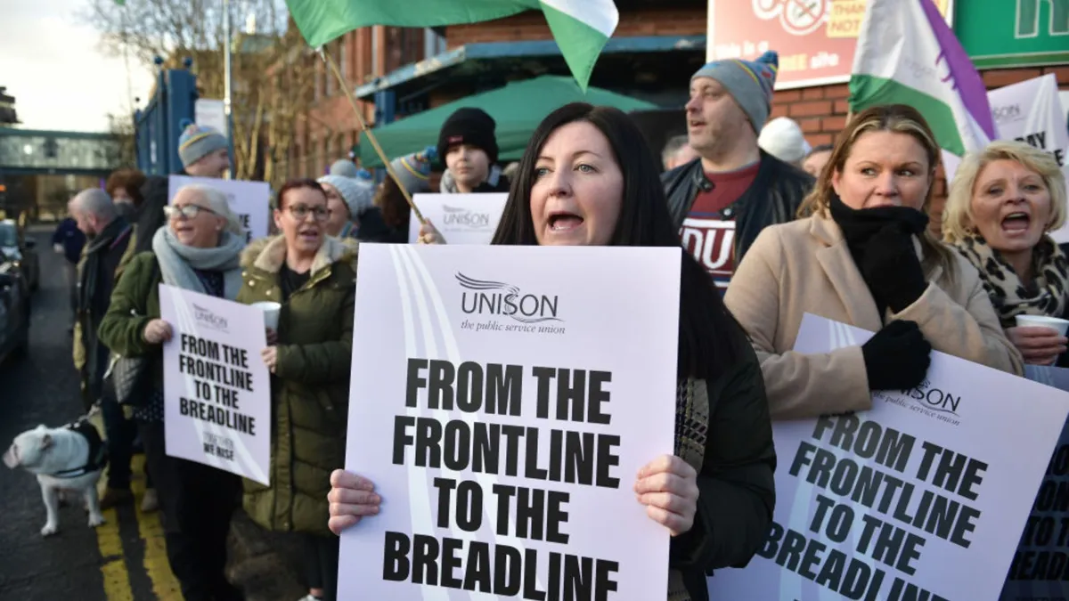 A group pf people protest while holding signs
