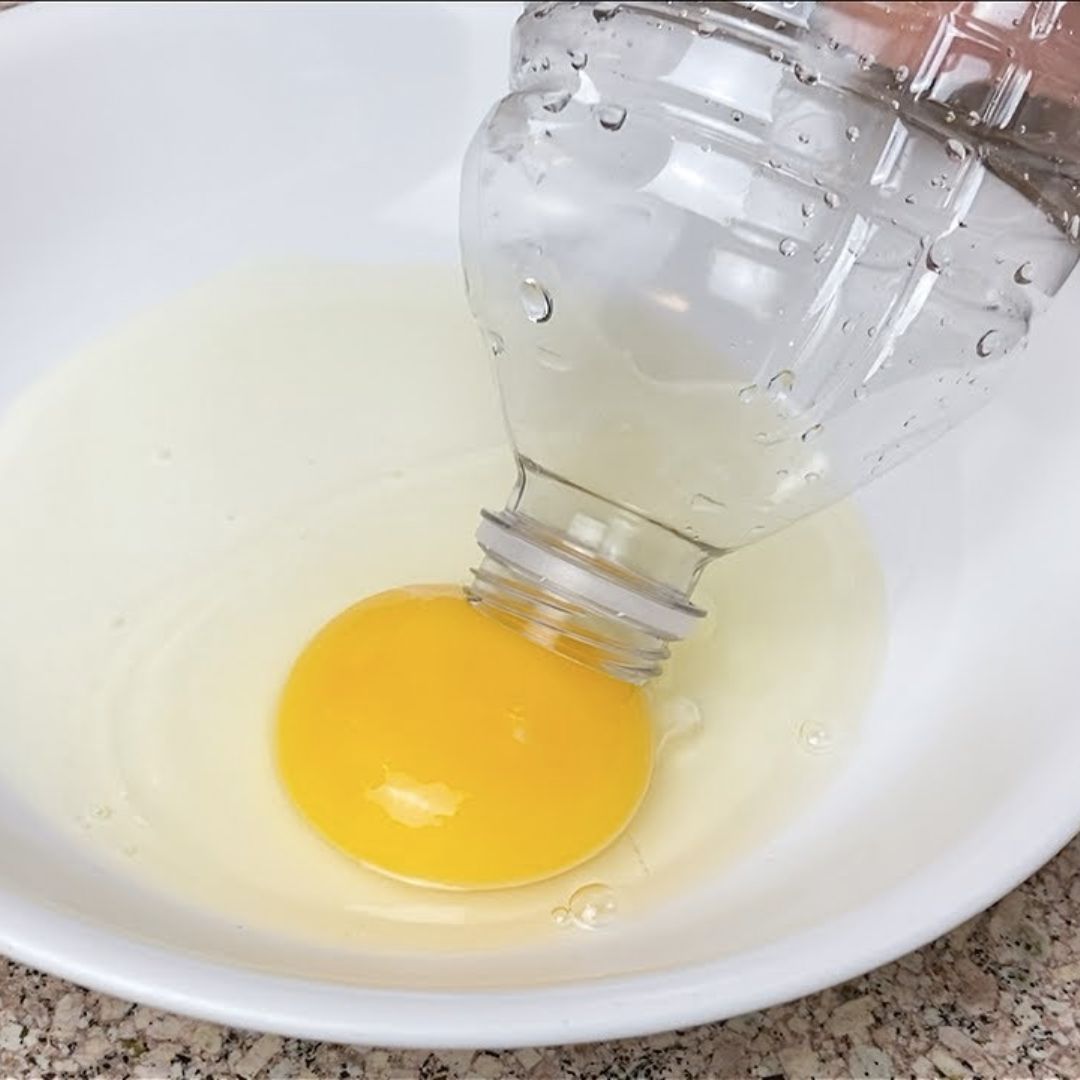 A plastic bottle above an egg yolk; archive shortcut image, not the recommended food-safe tool.