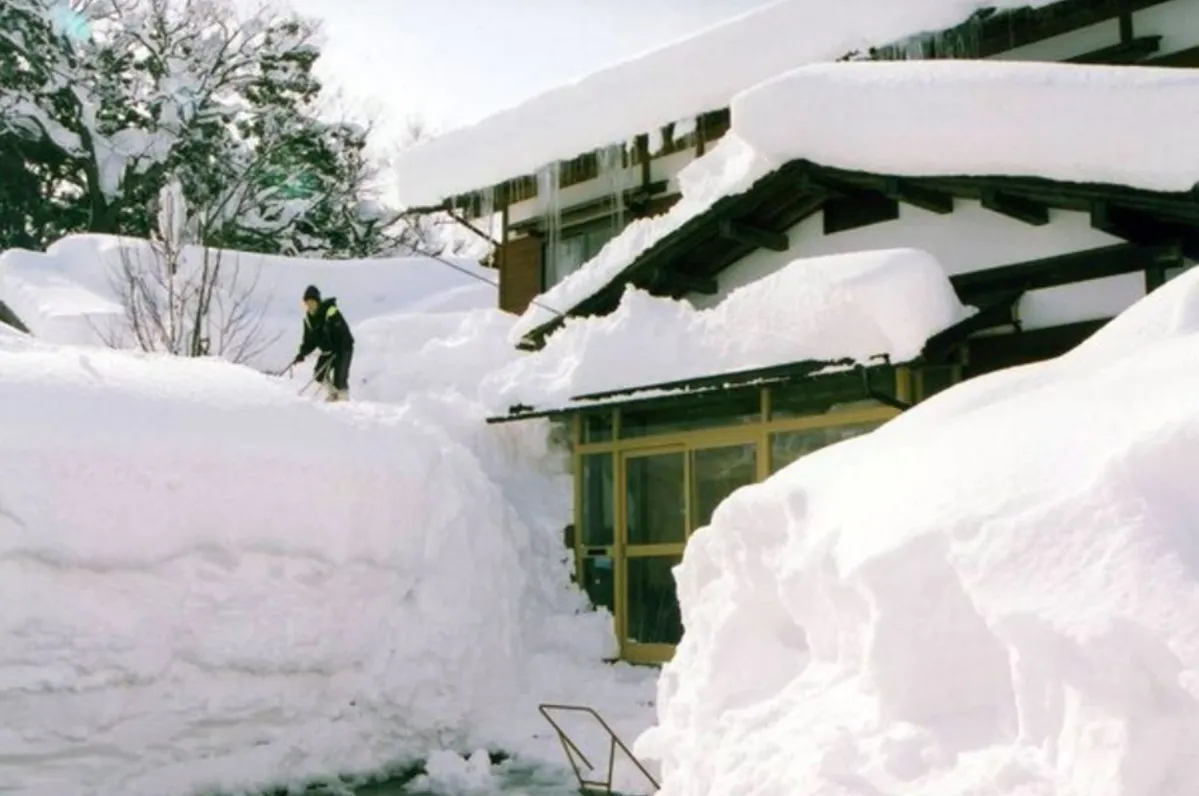 House entirely covered in heavy snowfall