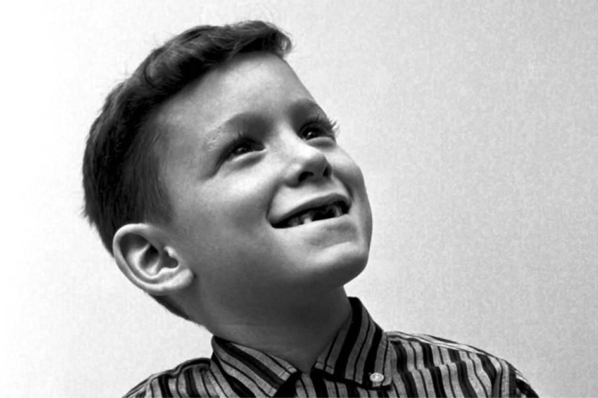 A smiling child with a missing front tooth