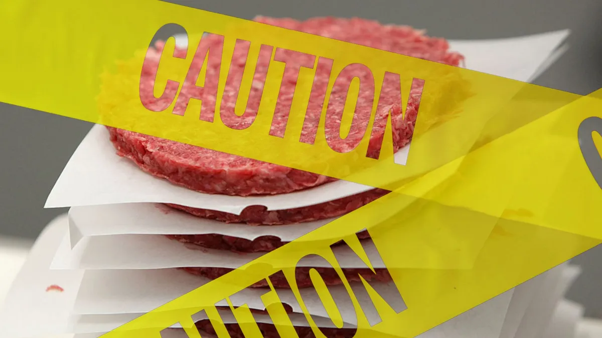 Caution tape over a stack of fresh burgers